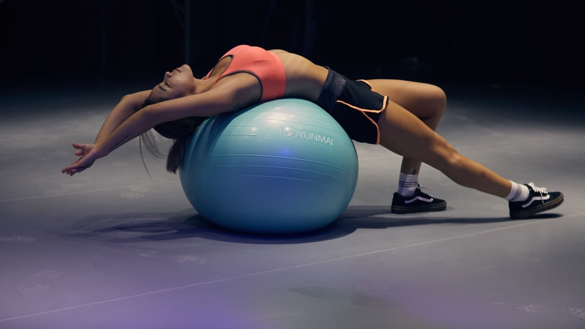 woman doing yoga on stability ball